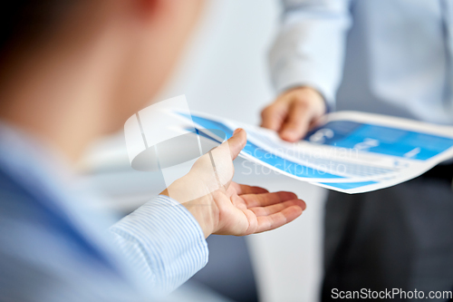 Image of close up of business team with papers at office