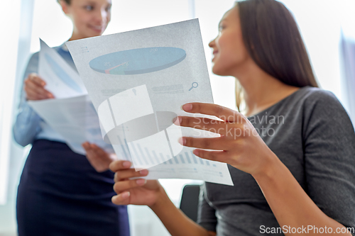 Image of happy business team with papers meeting at office