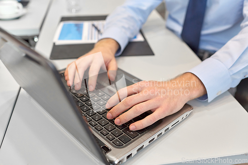 Image of close up of businessman with laptop at office