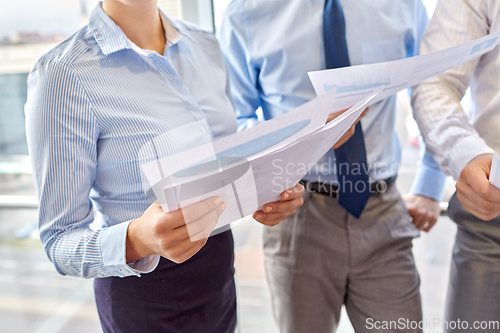 Image of business team with papers meeting at office