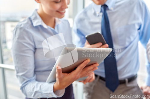 Image of business team with tablet pc and smartphone