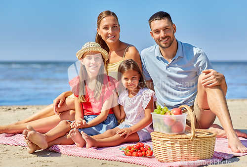 Image of happy family having picnic on summer beach