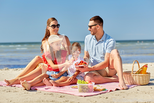 Image of happy family having picnic on summer beach