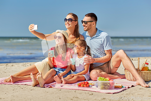 Image of happy family taking selfie on summer beach