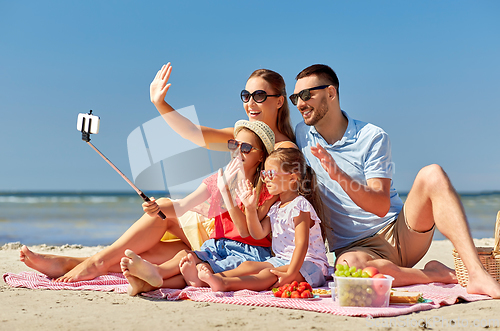 Image of happy family taking selfie on summer beach