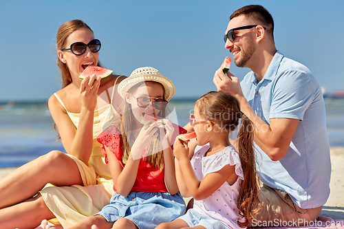 Image of happy family having picnic on summer beach