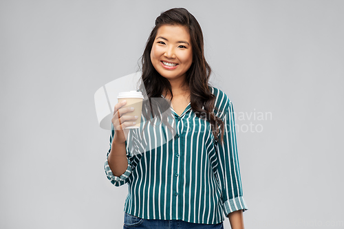 Image of happy asian woman drinking coffee