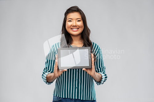 Image of happy asian woman using tablet computer