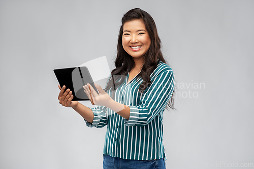 Image of happy asian woman using tablet computer