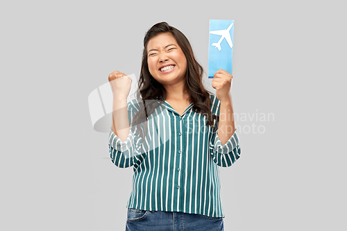 Image of happy asian woman with air ticket and passport