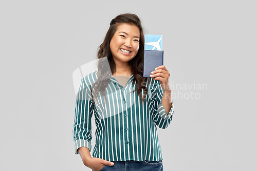 Image of happy asian woman with air ticket and passport