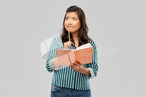 Image of asian student woman with diary and pencil