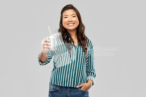 Image of happy smiling asian woman with can drink
