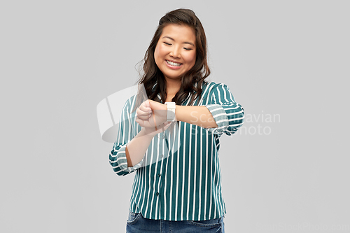 Image of happy smiling woman with smart watch