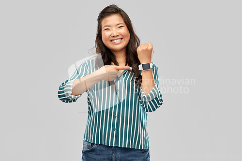 Image of happy smiling woman with smart watch