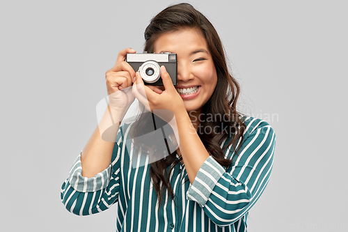 Image of asian female photographer with digital camera