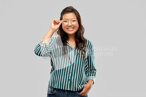 Image of happy asian woman in glasses or student