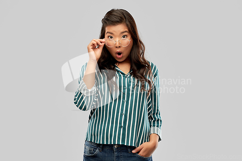 Image of surprised asian woman in glasses or student