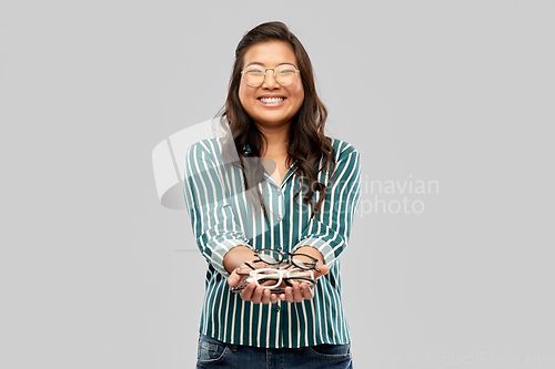 Image of happy smiling asian woman in glasses or student