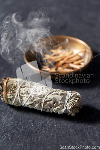 Image of white sage and cup with smoking matches