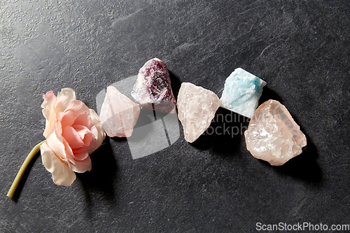 Image of quartz crystals, gem stones and rose flower