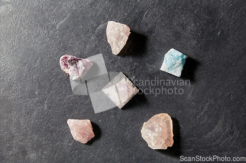 Image of quartz crystal pyramid and gem stones on slate