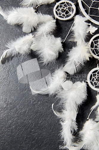 Image of dreamcatcher on dark slate stone background