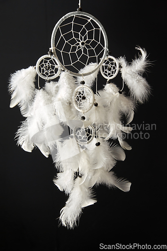 Image of white dreamcatcher on black background