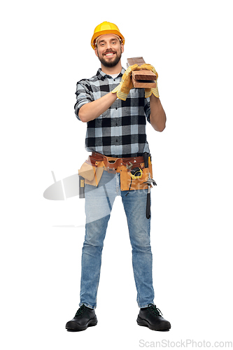 Image of happy male worker or builder in helmet with boards