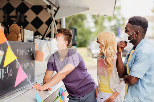 Image of customers in masks at food truck