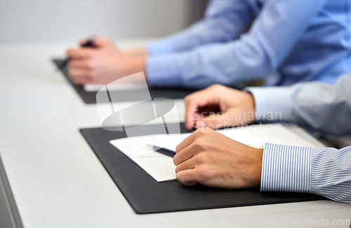 Image of close up of businessman with papers at office