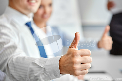 Image of close up of businessman showing thumbs up