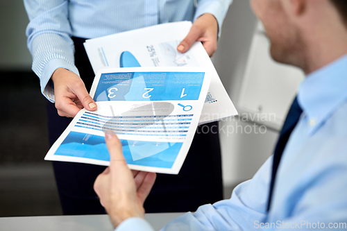 Image of close up of business team with papers at office