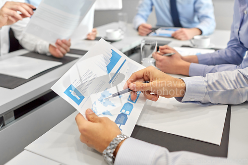 Image of business team with papers meeting at office