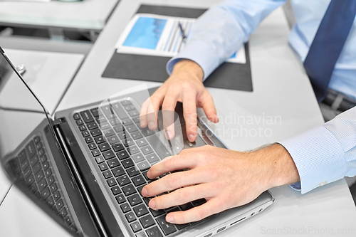 Image of close up of businessman with laptop at office