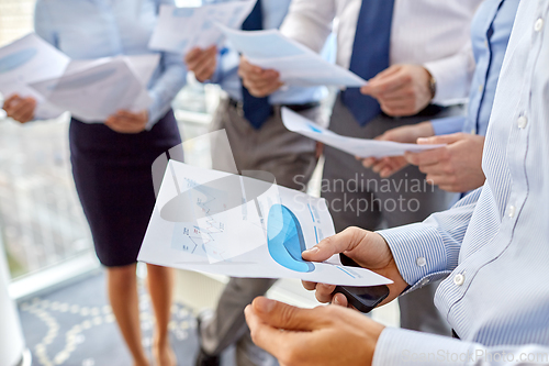 Image of business team with papers meeting at office