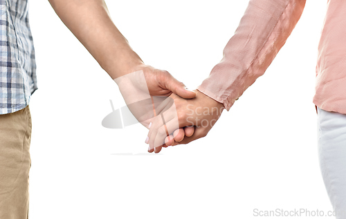 Image of close up of happy couple holding hands at home