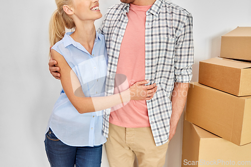 Image of happy couple with boxes moving to new home