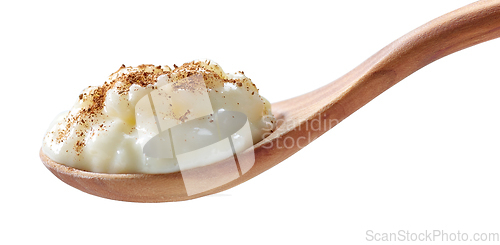 Image of rice milk pudding in a wooden spoon