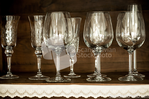 Image of glasses on the shelf of an old cabinet