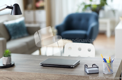 Image of laptop and stationary on table at home office