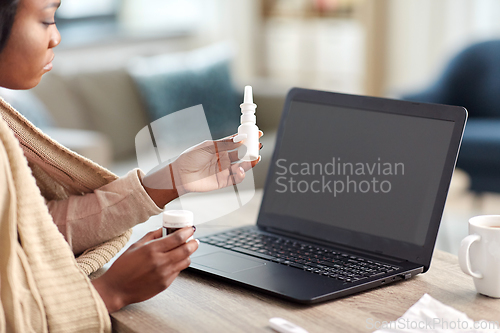 Image of sick woman having video call on laptop at home