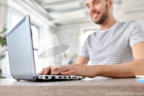 Image of man with laptop working at home office