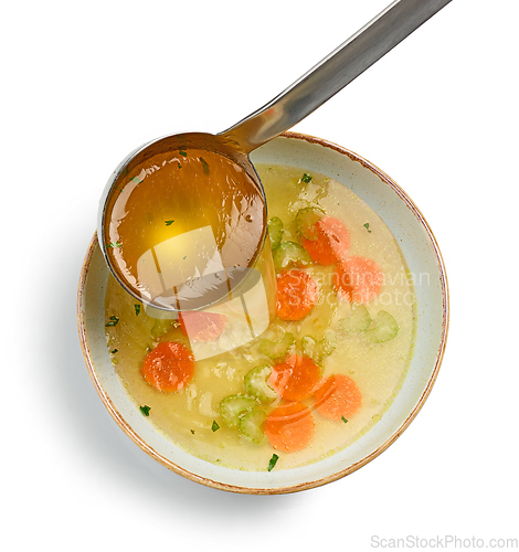 Image of broth soup pouring into bowl