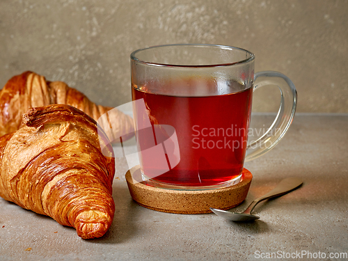 Image of close up of tea cup and croissants