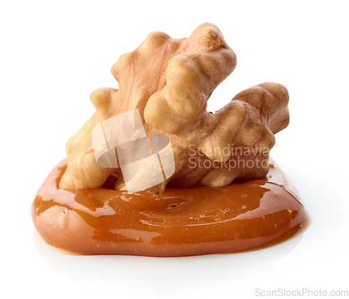 Image of walnut in melted caramel