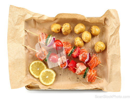 Image of fresh raw salmon and vegetable skewers and potatoes