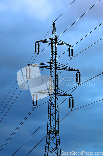 Image of High voltage tower against the evening cloudy sky