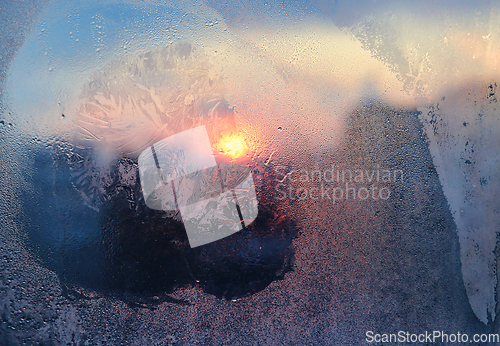 Image of Ice pattern and water drops on glass on a sunny winter morning