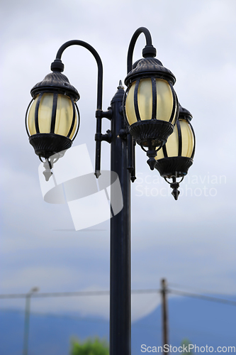 Image of Vintage street lamp against a cloudy sky